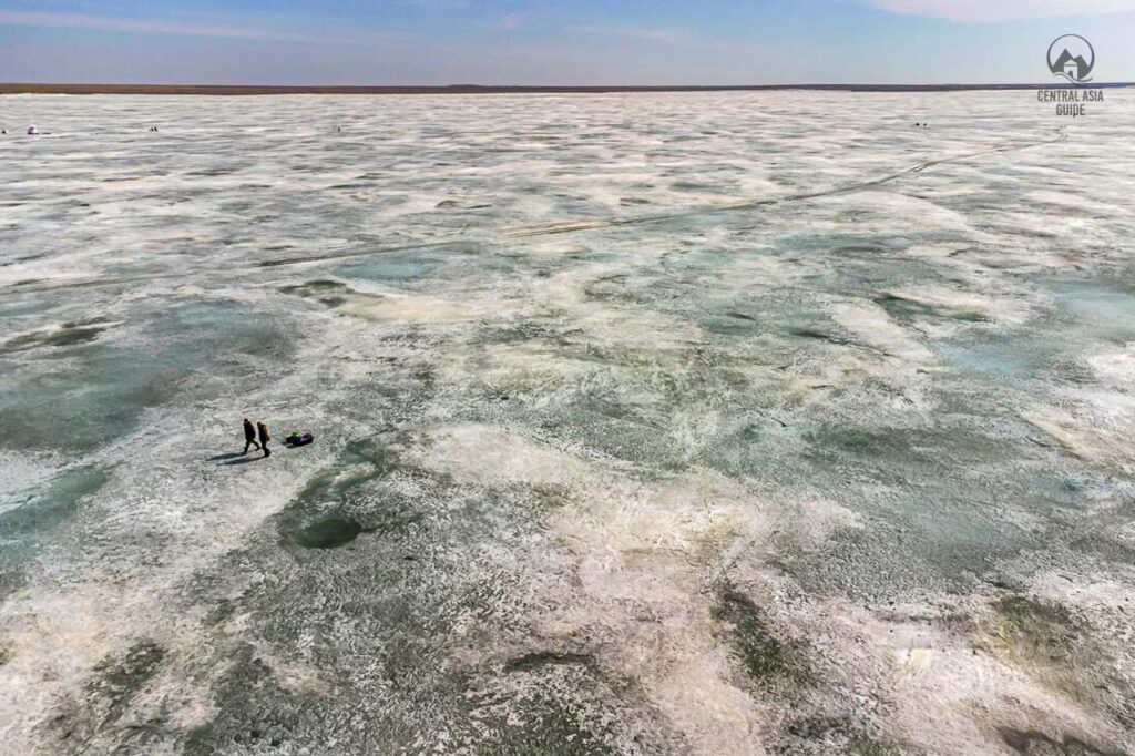 Fishermen walking on Lake Tengiz Korgalzyn UNESCO site in Northern Kazakhstan steppes