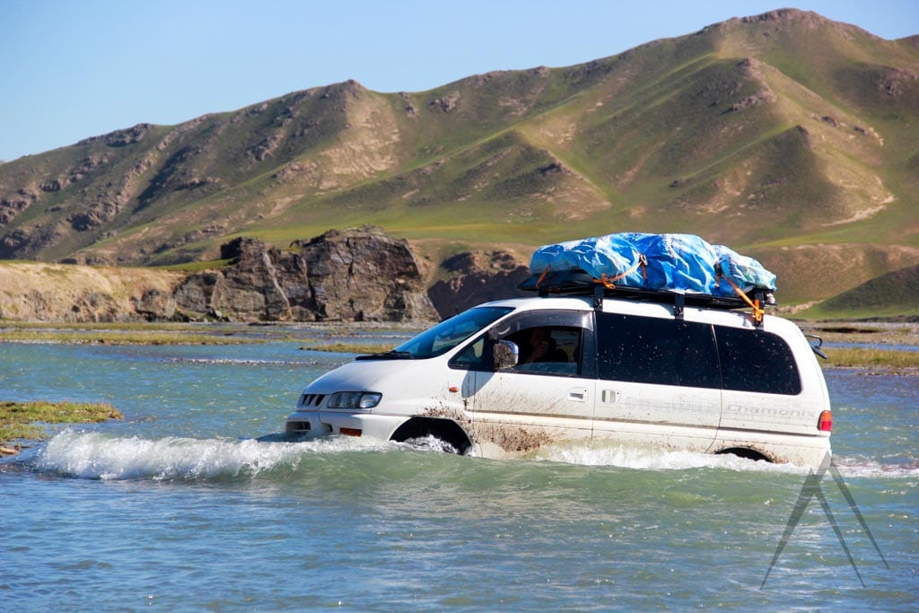 Off road crossing river in Kyrgyzstan with car