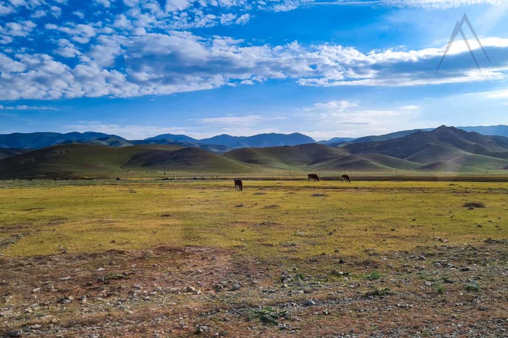 Nuratau black mountains with a small house in Uzbekistan