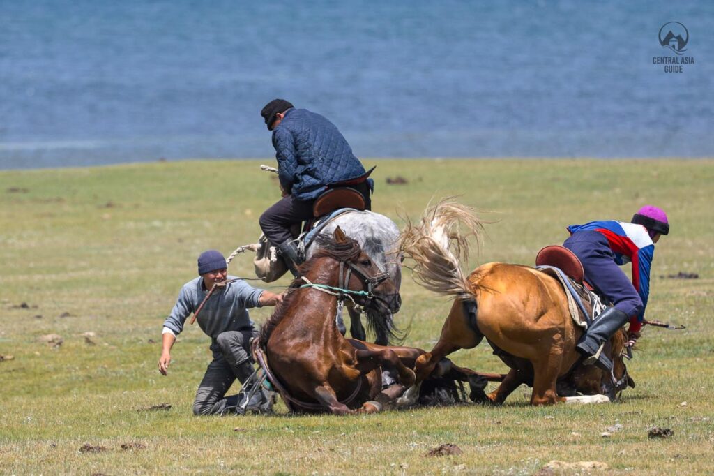 Horses and players falling during a kok boru horse game in Song Kul lake